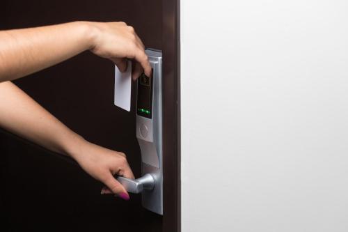 a woman is holding the door of a refrigerator at La Terraza Hotel in Jalpan