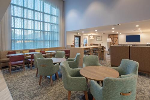 a waiting room at a hospital with tables and chairs at Staybridge Suites - Carson City - Tahoe Area by IHG in Carson City