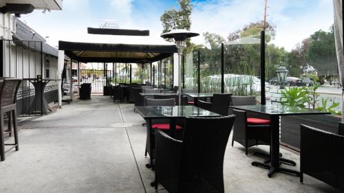 a row of tables and chairs on a patio at Americas Best Value Inn Rancho Palos Verdes in Rancho Palos Verdes