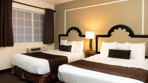 a hotel room with two beds in a room at Americas Best Value Inn Rancho Palos Verdes in Rancho Palos Verdes