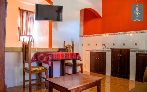 a kitchen with a table with a red cloth on it at Hotel Casa Texel in Panajachel