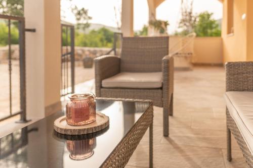 a glass table with a candle on top of it at Villa Strikina kuca in Slivno