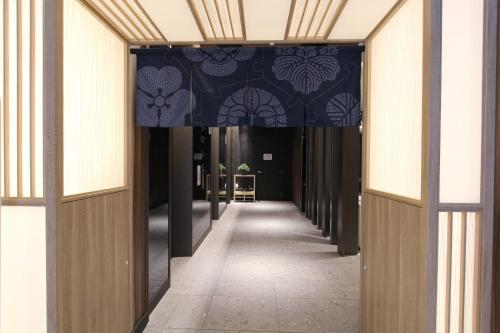 a hallway in a building with a blue and white ceiling at KOKO HOTEL Tsukiji Ginza in Tokyo
