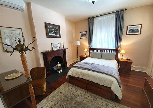 a bedroom with a bed and a fireplace at Burra Railway Station BnB in Burra