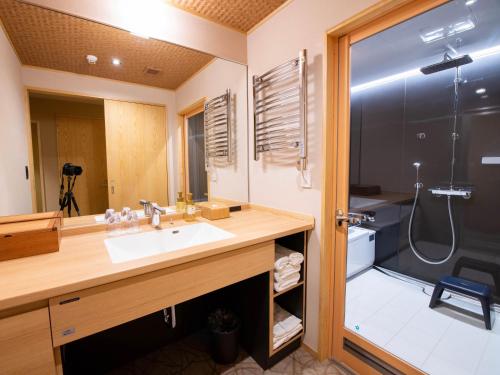 a bathroom with a sink and a shower at Nagi Kyoto Shijo in Kyoto