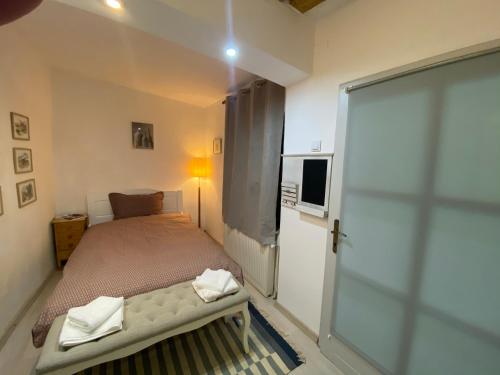 a small bedroom with a bed and a sliding glass door at Lyric Studio in Sibiu