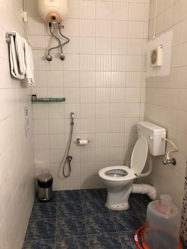 a bathroom with a toilet and a shower at Hotel Saluja in Siliguri