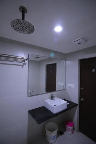 a bathroom with a sink and a mirror at Hotel Marygold By The Golden Taj Group & Hotels in Agra