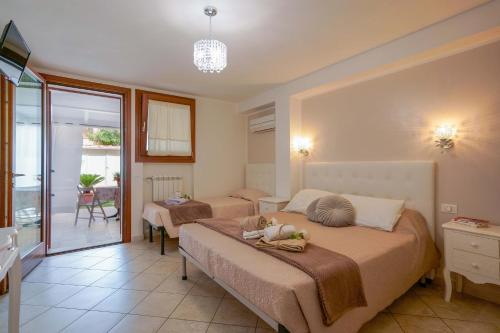 a bedroom with two beds and a balcony at Casa Nostra in Pula