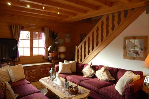 a living room with a couch and a staircase at Room in Guest room - Mont Blanc room for 3 people with a balcony in Morillon