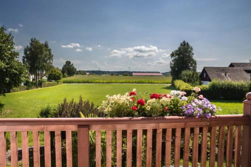 a wooden fence with a bunch of flowers on it at Glasl's Landhotel in Zorneding