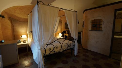a bedroom with a bed with a canopy at Stella Maris Resort in Camogli