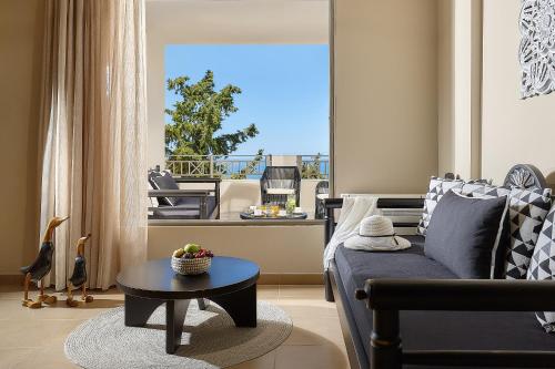 a living room with a couch and a table at Grace Villas Collection in Hersonissos