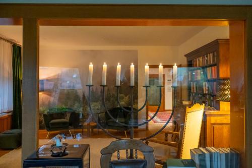 a living room with a chandelier with candles in it at NATURION Hotel Hinterzarten in Hinterzarten