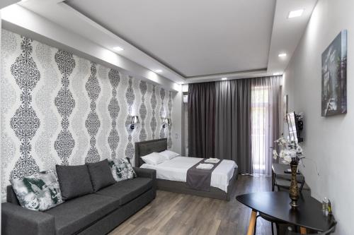 a living room with a couch and a bed in a room at Golden Room Apartments 04 in Tbilisi City