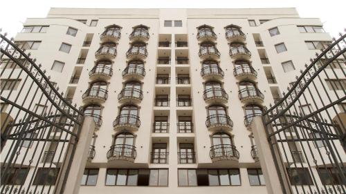 a tall white building with balconies on it at The Grand Palace Hotel in Addis Ababa