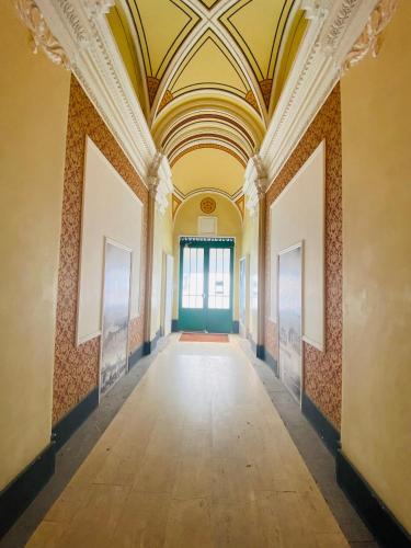 an empty hallway in a building with a ceiling at OPERA16 Guestrooms in Budapest