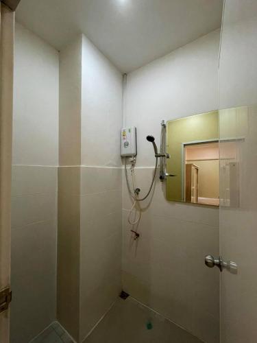 a bathroom with a shower and a mirror at Bake Room Hostel in Chiang Mai