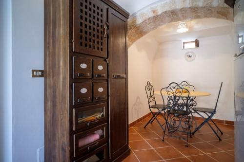 a dining room with a table and a cabinet at Trulli Brunone in Castellana Grotte