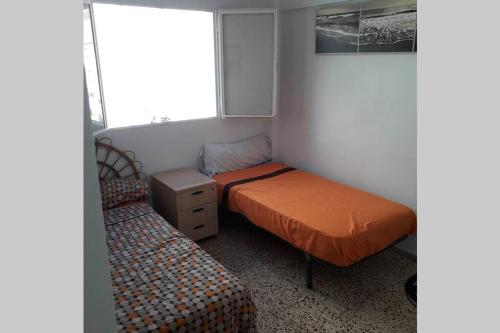 Habitación pequeña con 2 camas y ventana en Campello Alicante Playa en El Campello