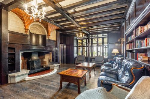 a living room with a couch and a fireplace at Best Western The Webbington Hotel & Spa in Loxton