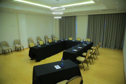 a meeting room with black tables and chairs at Check Inn Hotel Addis Ababa in Addis Ababa