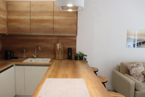a kitchen with a wooden counter top in a room at Baltic Nature in Łukęcin
