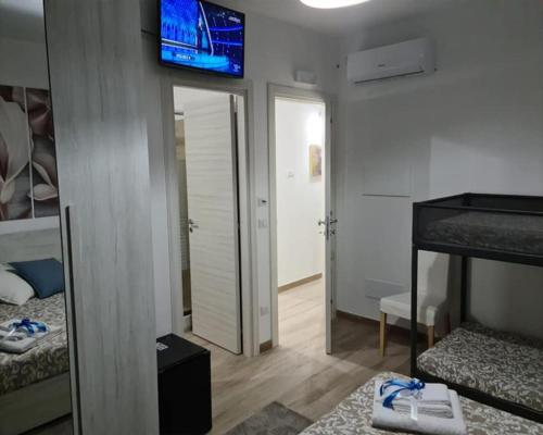 a room with two beds and a television on the wall at B&B Villa Chiara - Bed And Breakfast in Taormina