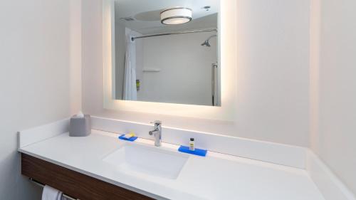 a bathroom with a white sink and a mirror at Holiday Inn Express & Suites Dinuba West by IHG in Dinuba