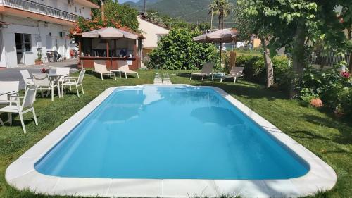 a swimming pool in the backyard of a house at Stelios House in Asprovalta