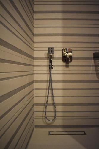 a bathroom with a shower with a shower head at Alto Suite (Cielo suites) in Kavala