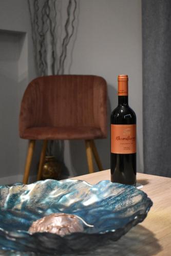 a bottle of wine sitting on top of a table at Alto Suite (Cielo suites) in Kavala