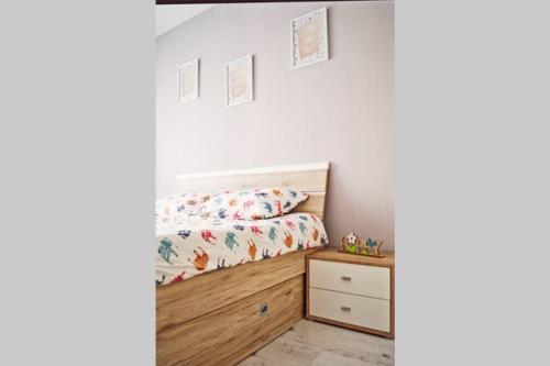 a bedroom with a bed and a dresser at Dream Apartment+parcare gratuita in Oradea