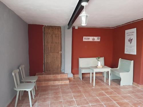 a room with chairs and a table and a door at Casa rural "Garnacha de Borja" guest home in Borja