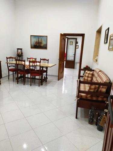 a dining room with a table and chairs at Nonno Ciccio Apartment in Lizzano