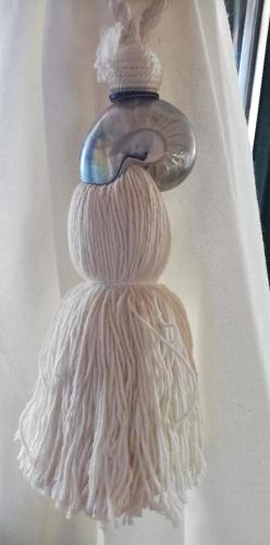 a white tassel hanging from a curtain at Olgas Villa in Aroyí