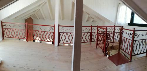 an empty room with a red railing on a balcony at Olgas Villa in Aroyí