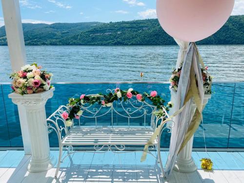 a bench on the deck of a cruise ship with a balloon at Riviera 990 - Resort & Restaurant in Eşelniţa