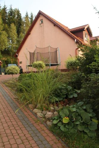 a building with a net on the side of it at DOMKI - Kaszuby Resort ZACISZE - new cottage in Chmielno