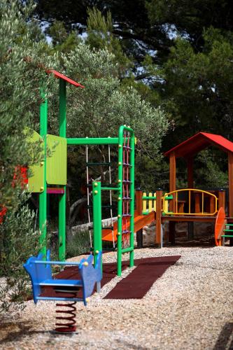 a park with a playground with a play equipment at Hotel Murter in Murter