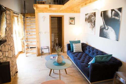a living room with a blue couch and a table at Kamena Kuća Hutovo Blato in Čapljina
