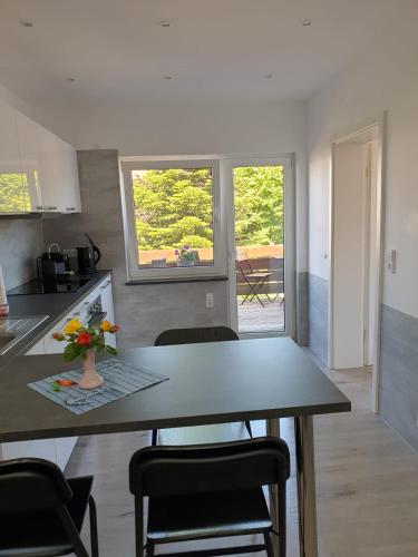 a kitchen with a table and chairs in a kitchen at DTS Appartements in Putbus