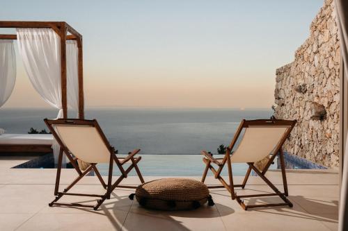two chairs sitting on top of a beach at Emerald Villas in Agios Nikolaos