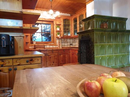 a kitchen with a wooden table with apples on it at Alm-Ferienhaus Gaisegg am Klippitztörl in Bad Sankt Leonhard im Lavanttal