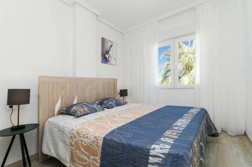 A bed or beds in a room at Apartment with pool TORREVISTA ROCIO