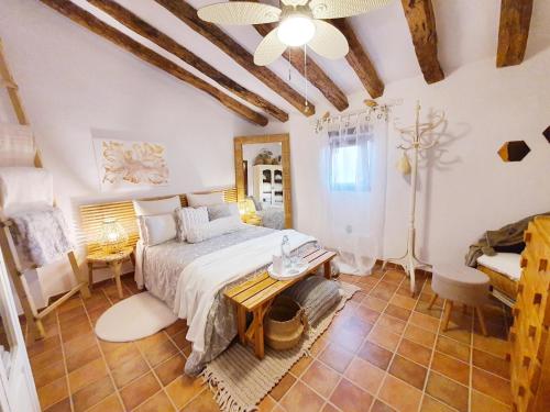 a bedroom with a bed and a table at La Ultima Casa Masboquera in Mas Boquera