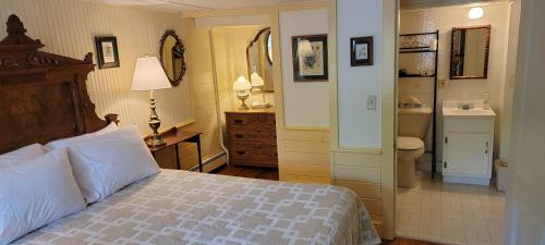 a bedroom with a bed and a bathroom at Hawks House Inn in Walpole