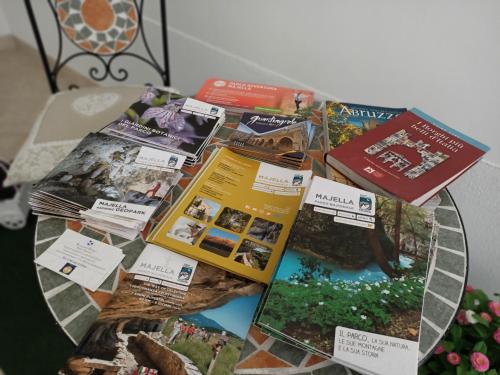 a table with a bunch of books on it at Romantico Rifugio in Guardiagrele