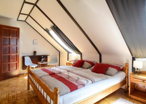 A bed or beds in a room at Valley Vendégház