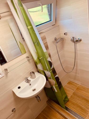 a bathroom with a sink and a shower at Bitter súkromné ubytovanie in Štúrovo